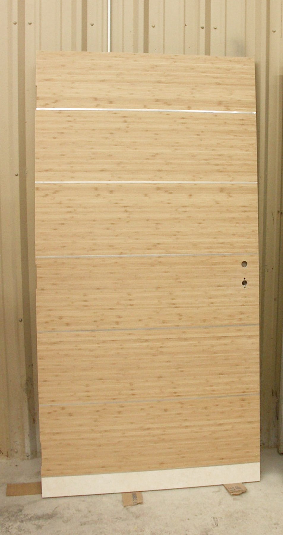 Horizontal bamboo veneer door with stainless steel inlay strips
