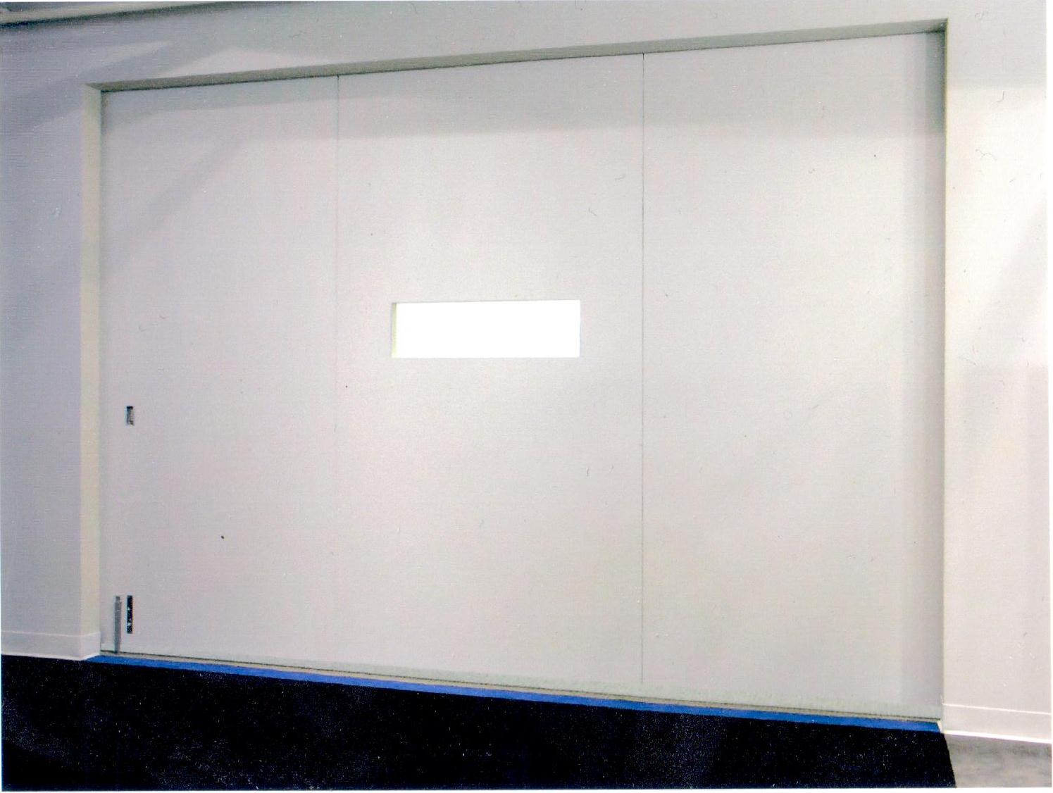 Large sliding barn door with plastic laminate faces, hung on a roller system