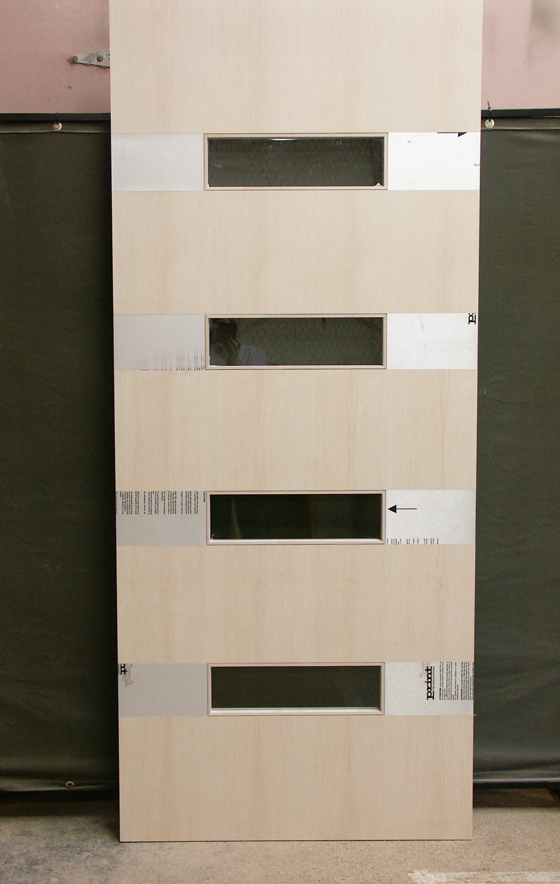 White birch door with lites and stainless steel inlays, protective film still on the inlays
