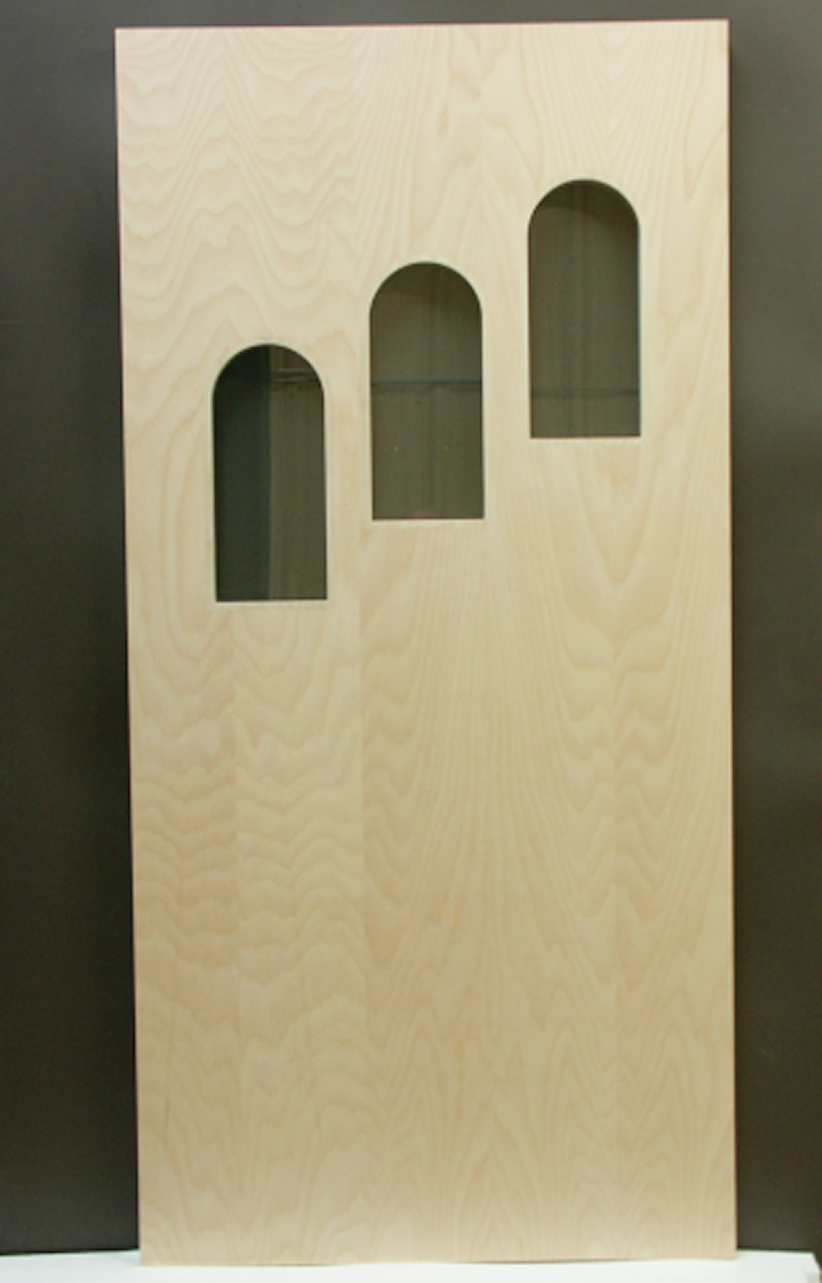 Plain sliced maple door with three arched glass cutouts