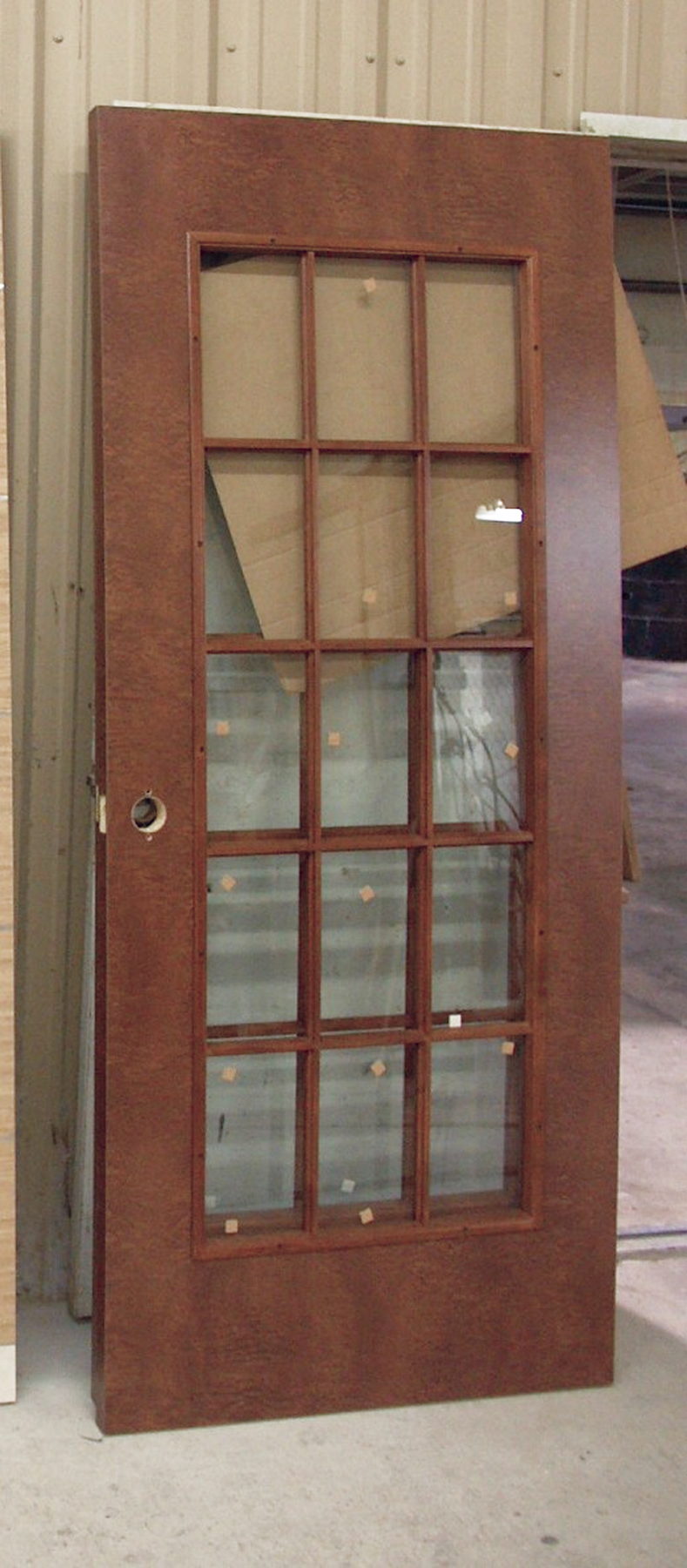 Dark-stained door with fifteen divided glass lites