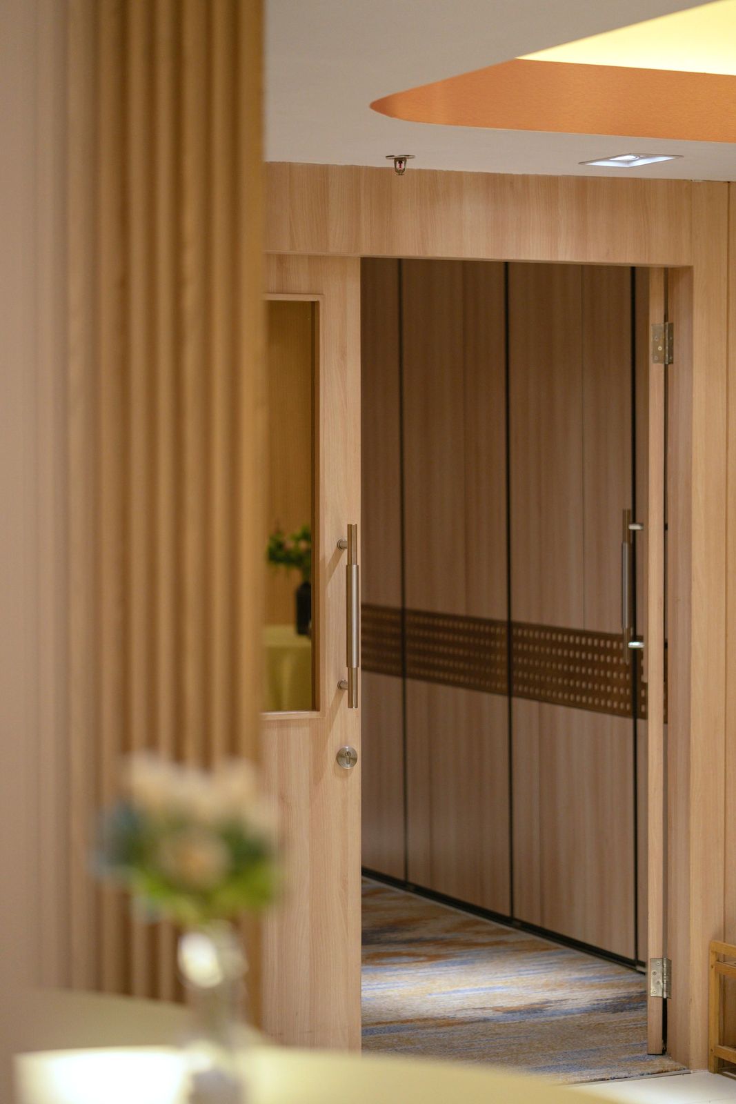 Wood doors with a perforated metal band and a glass vision lite